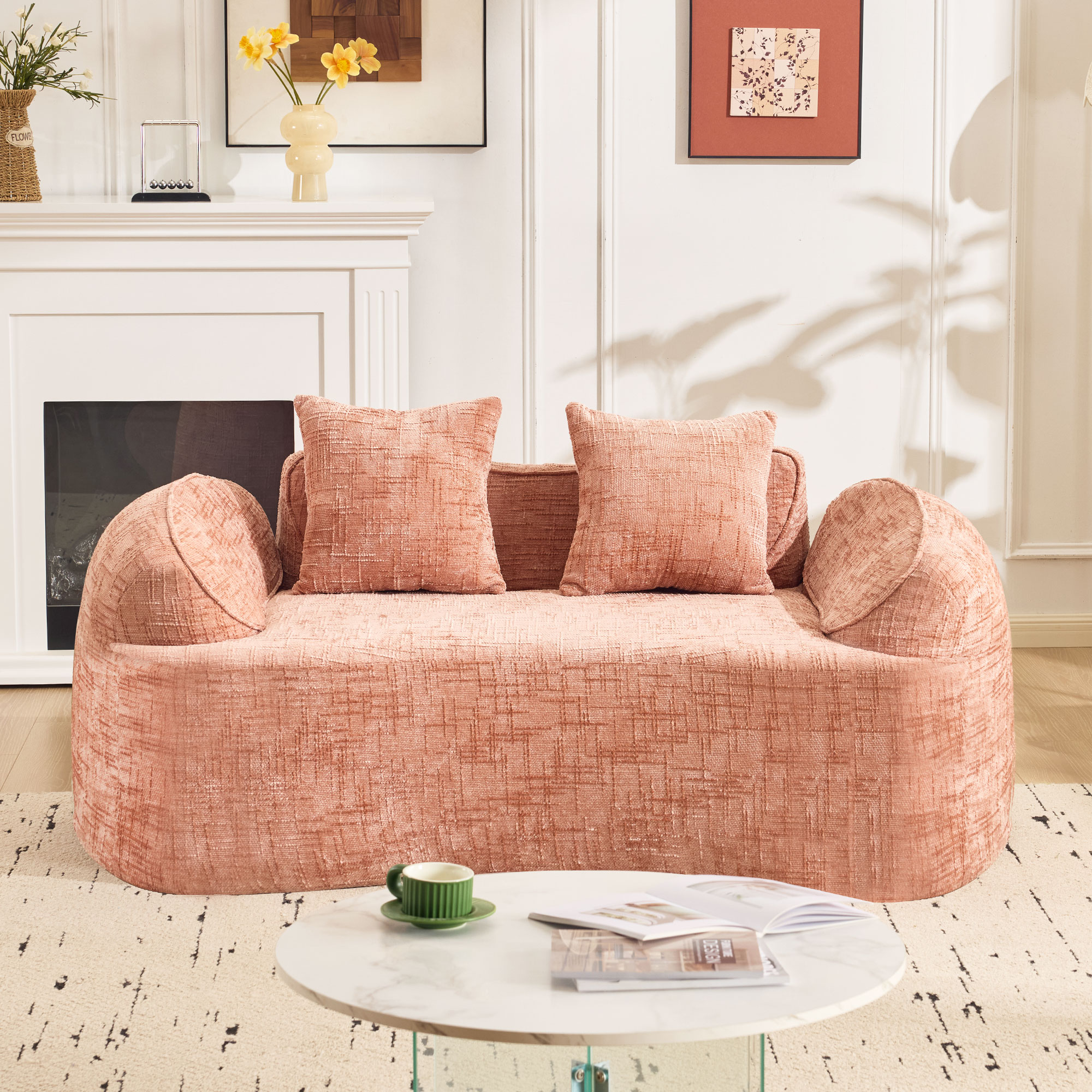 Pink curved two - person compress sofa. It has armrests on both sides, comes with two pillows, is suitable for small - sized apartments, and can be placed in the living room or bedroom.